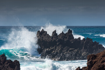 Fototapeta premium Powerful waves against the sea stacks of Lanzarote island, Atlantic Ocean, Canary Islands in Spain