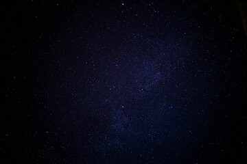 View of a night sky with small stars shining in the far