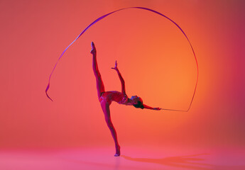 Beautiful and flexible graceful athlete rhythmic gymnastic artist dancing, doing stretch exercises...