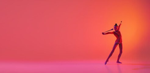 Dance. Young flexible teen girl rhythmic gymnast in motion, action isolated over pink background in neon. Sport, beauty, competition, flexibility, active lifestyle