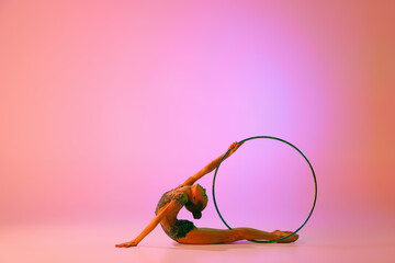 Beautiful and flexible graceful athlete rhythmic gymnastic artist dancing, doing stretch exercises...