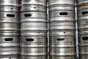 Aluminum alloy metal kegs for beer stand in a row.