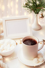  Winter, Christmas, New Year decorations composition, concept, background. White Mug, cup of tea, coffee, steam, meringue, knitted plaid. Christmas lights. Christmas mood morning. Christmas  card.