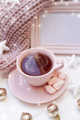   Winter, Christmas, New Year decorations composition, concept, background. Mug, cup of tea, coffee and meringue. Christmas lights. Christmas mood. Morning, breakfast. Christmas greeting card.