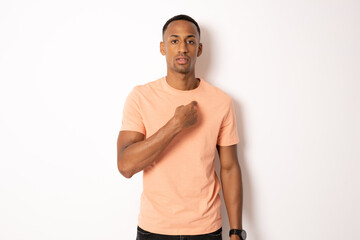 Young african american man wearing t-shirt standing over isolated white background pointing oneself with finger.