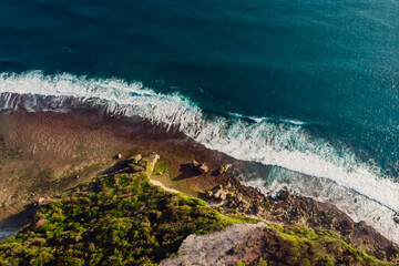Aerial view of coastline with cliffs and ocean with waves