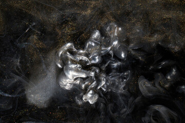 Golden sparkling abstract background, luxury black smoke, acrylic paint underwater explosion, cosmic swirling ink