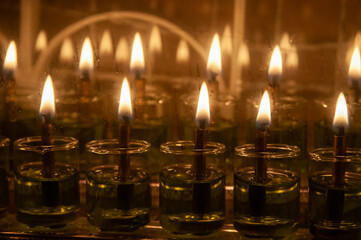 Hanukkah candles burning outside a home in Jerusalem, where it is traditional to burn oil instead...