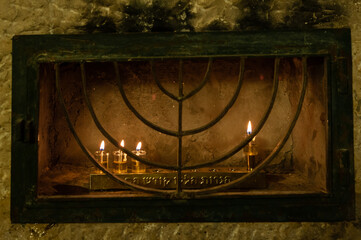 Hanukkah candles burning in protective glass housing in Jerusalem, where it is traditional to burn oil instead of wax in small vials during the celebration of the Festival of Lights in Israel.