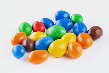 Chocolate coated Peanuts. Colorful chocolate buttons, on white background.