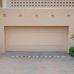 Square White puffy clouds Garage exterior with beige walls and doors at La Jolla, California