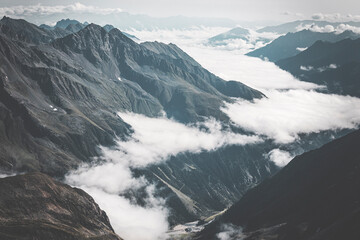 snow covered mountains and clouds