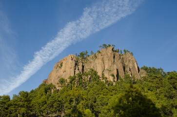 Cliff of the Morro de Pajonales and vapor trail of an aircraft. Integral Natural Reserve of Inagua. Tejeda. Gran Canaria. Canary Islands. Spain.