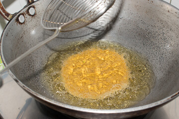 Step by step process of Deep frying Poori or Luchi in oil . Indian fried bread made from wheat flour.