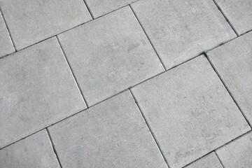 View of the gray pedestrian tiles in the city.