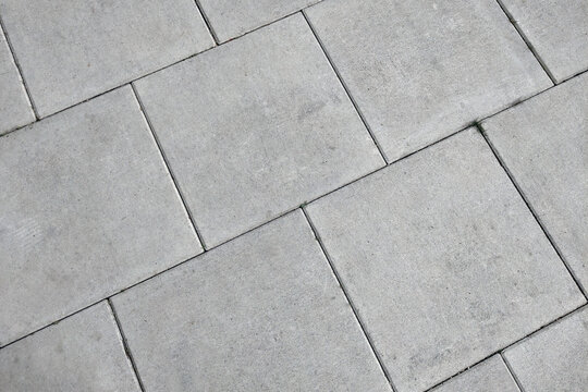 View of the gray pedestrian tiles in the city.