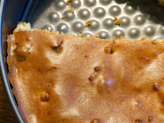 Pie in a baking dish with a piece already cut off. View from above