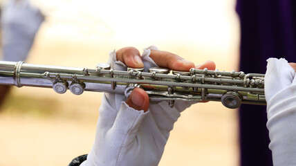 Fototapeta premium Flute is being played by a student at the marching band rehearsal with blur background 