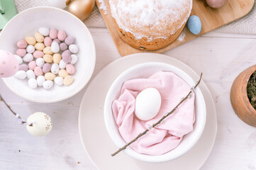 happy easter and spring holidays time. festive tablescape set decor. traditional dinner food easter eggs and baked cakes on table at home. pale pop pastel blue and pink color. top view