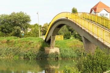 Fototapeta premium Concrete bridge for pedestrians and cyclists across the river