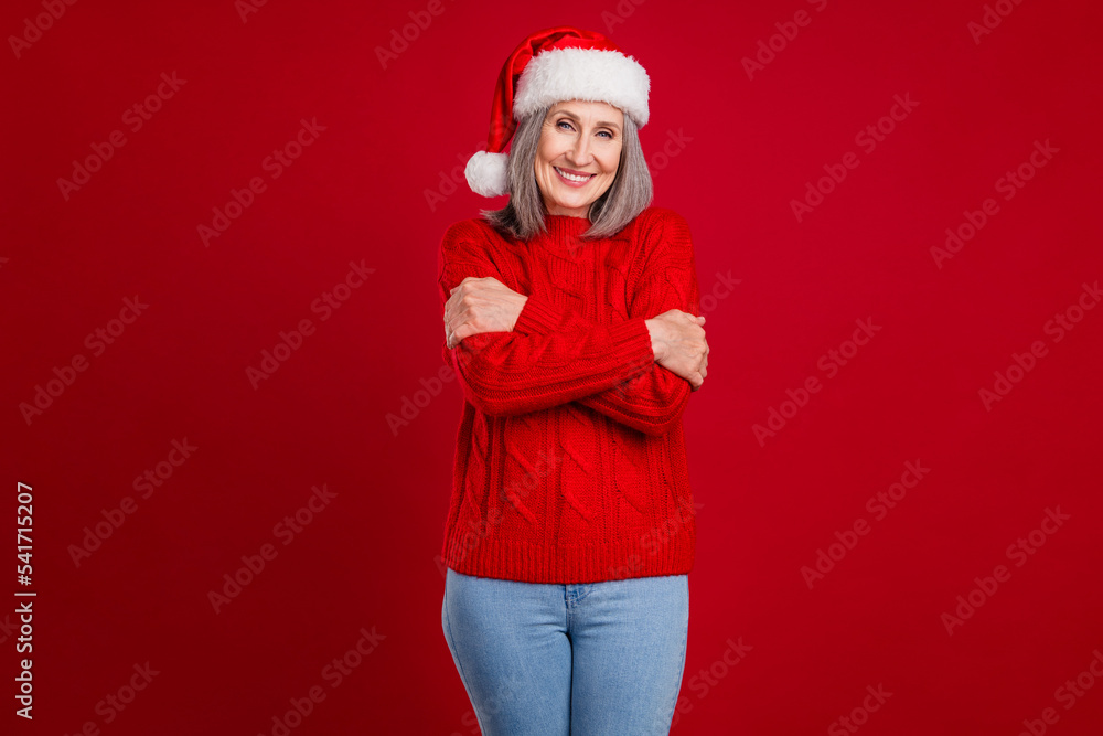 Sticker Photo of cheerful peaceful grandma embrace shoulders enjoy warmth wear hat knitted sweater isolated red color background