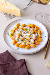 Pumpkin gnocchi with Parmesan cheese and herbs. Healthy eating. Vegetarian food.