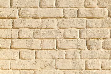 Brick wall with biege plaster texture background