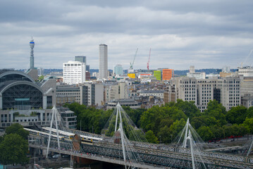 Aerial view of Hungerford Railway Bridge and Golden Jubilee Bridges at City of Westminster on a cloudy summer day. Photo taken August 3rd, 2022, London, United Kingdom.