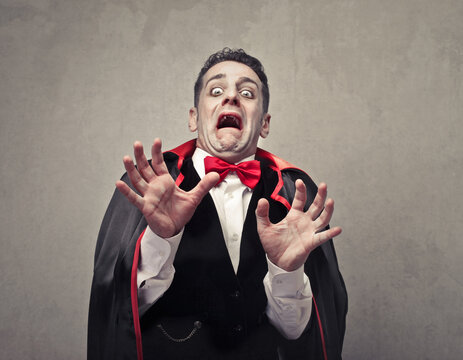 man disguised as a scared vampire