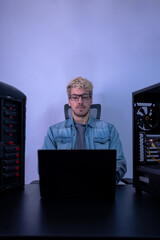 Caucasian man working with programming in dark background. Hacker, engineer, program developer...