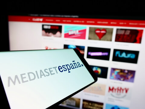 Stuttgart, Germany - 10-24-2022: Smartphone with logo of Spanish media company Mediaset Espana on screen in front of business website. Focus on center of phone display.