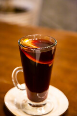 glass of mulled wine on a wooden table close-up, selective focus