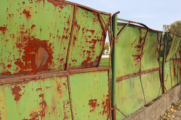 Rusty old metal fence in the city