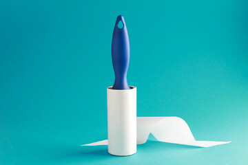 Cloth fabrics cleaner lint roller brush with paper roll blue grip on mint green blue color...