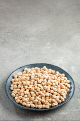 Raw chickpeas in the plate on the table.