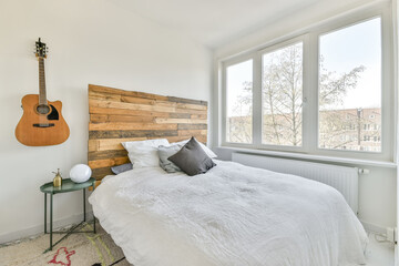 Minimalist style bedroom with bed and guitar decorations
