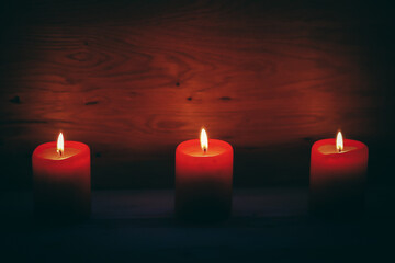 three candles on an abstract festive background. holiday concept