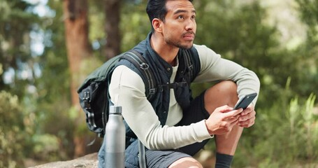 Nature hiking man, typing phone and sitting on rock for rest, break or relax with backpack outdoor. Forest adventure, woods explorer and smartphone for coordinate direction on gps navigation by trees - Powered by Adobe