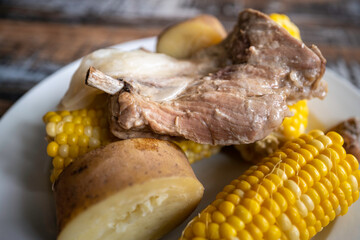 Slow-cooked pork rib and potato and grilled corn on the cob, homemade paleo diet meal plan