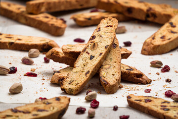 Homemade crunchy biscotti cookie stack with cranberry and pistachio nuts. Biscotti or cantucci are traditional italian baked sweet biscuits, popular during winter holidays as a snack or dessert