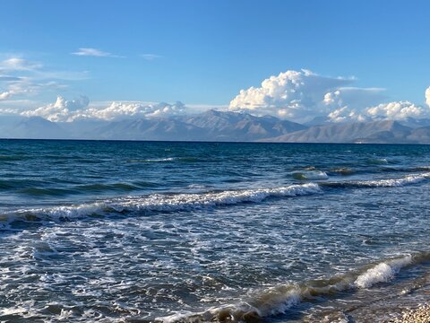 stormy sea in Acharavi, small resrt in Corfu island, Greece with Albania mountains in a distance