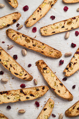 Biscotti cookies with cranberry and pistachio nuts in vertical flat lay view. Biscotti or cantucci are traditional italian baked sweet biscuits, popular during winter holidays as a snack or dessert
