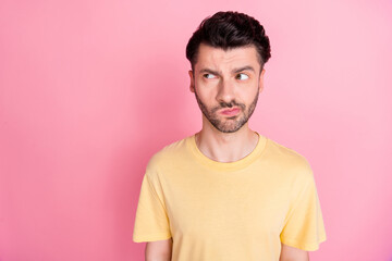 Portrait of distrust thoughtful curious man with stylish haircut wear yellow t-shirt look empty...