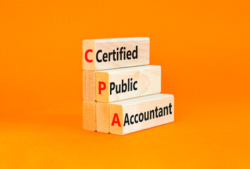 CPA certified public accountant symbol. Concept words CPA certified public accountant on wooden blocks on a beautiful orange background Business and CPA certified public accountant concept. Copy space