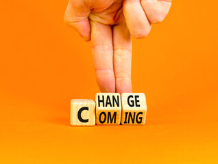Change is coming symbol. Concept words Change and Coming on wooden cubes. Beautiful orange table orange background. Businessman hand. Business change is coming concept. Copy space.