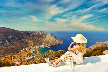 Young woman looking at Kamares beach of Sifnos island, Greece - obrazy, fototapety, plakaty