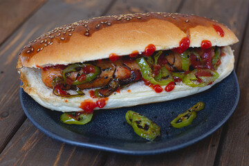 Hot dog with fried sausage and green pepper