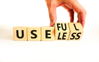 Useful or useless symbol. Concept words Useful or Useless on wooden cubes. Businessman hand....