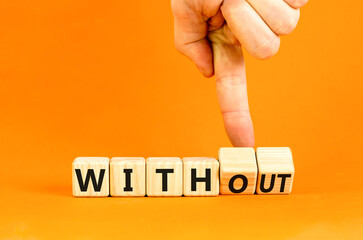 Without or with symbol. Concept words Without and With on wooden cubes. Beautiful orange table orange background. Businessman hand. Business without or with concept. Copy space.