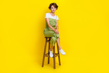 Full length size cadre of stylish cute businesswoman sitting chair crossed legs office pause weekend isolated on bright yellow color background